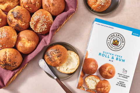 Guten-Free rolls and buns in a basked with another sliced and buttered on a plate and a box of King Arthur Baking's GF Roll & Bun Mix in the frame. - select to zoom