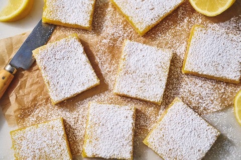 Gluten-Free Lemon Squares with an Almond Flour Crust on parchment paper. - select to zoom
