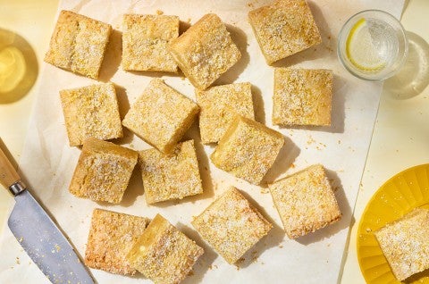 Alex Roberts Lemon Citrus Blondies on parchment paper atop a counter. - select to zoom