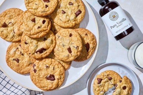 Cream Cheese Chocolate Chip Cookies arranged on a counter with King Arthur Vanilla shown on the counter. - select to zoom