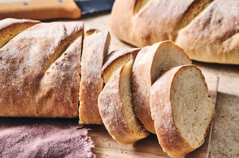 The easiest loaf of bread you'll ever bake shown sliced on a counter. - select to zoom