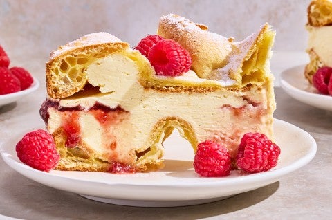 Karpatka Cake on a plate decorated with fresh raspberries. - select to zoom