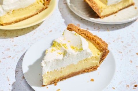 A slice of Lemon Cream Pie on a white plate. - select to zoom