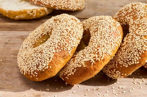 Sesame Sourdough Discard Bagels arranged on a table top. - select to zoom