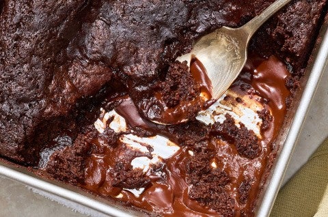 Sourdough Discard Chocolate Pudding Cake in a baking pan with a dollop on a spoon. - select to zoom