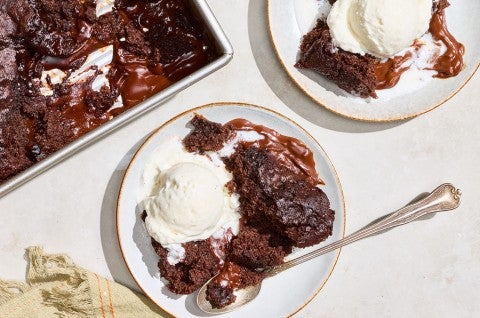 Sourdough Discard Chocolate Pudding Cake on plates with vanilla ice cream. - select to zoom