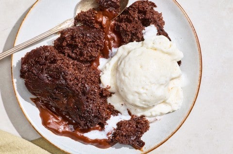 Sourdough Discard Chocolate Pudding Cake on a plate with vanilla ice cream. - select to zoom