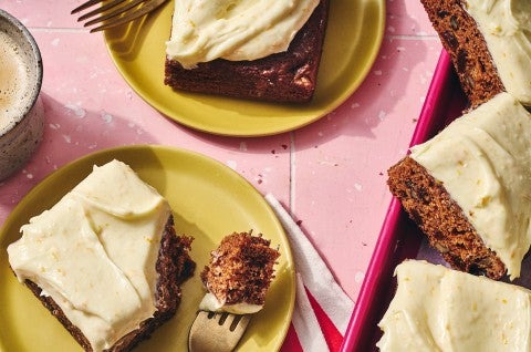 Tomato Soup Spice Cake sliced and shown on a plate with a bite on a fork. - select to zoom