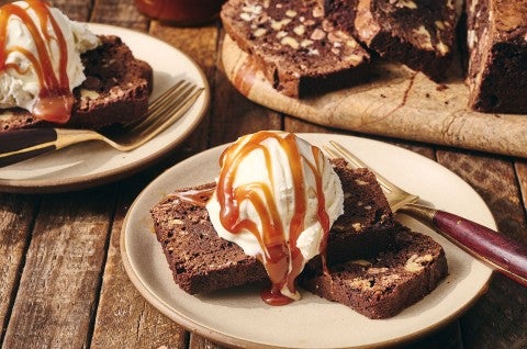 A sliced Brownie Loaf on a plate with vanilla ice cream and a caramel swirl - select to zoom