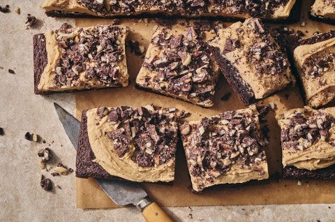 Chocolate Caramel Almond Crunch Brownies sliced and arranged on a counter, seen from above. - select to zoom