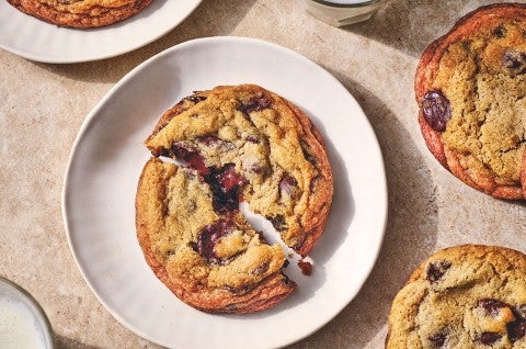 A Classic Chocolate Chip Cookie split on a white plate seen from overhead. - select to zoom
