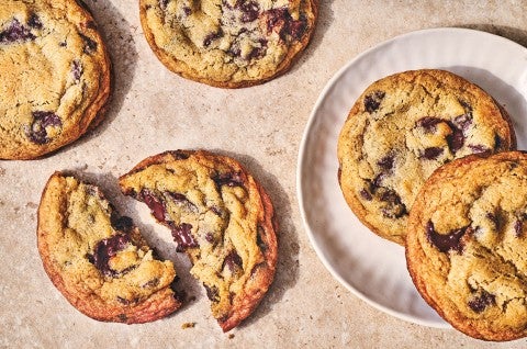 Classic Chocolate Chip Cookies spread out on a countertop. - select to zoom