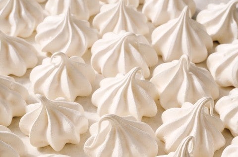 Detailed shot of Meringue Kisses tightly organized on a counter. - select to zoom