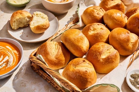 Soft Golden Buns & Rolls in a basket on a table - select to zoom