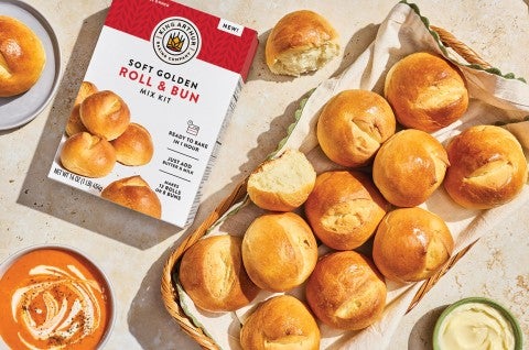 Soft Golden Buns & Rolls in a basket on a table with a box of King Arthur Baking Soft Golden Buns & Rolls mix - select to zoom