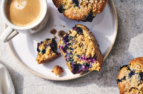 A Sourdough Discard Blueberry Muffin broken apart to show the crumb. - select to zoom