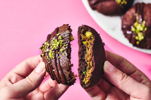 Breaking a Dubai Chocolate Cookie in half to show the filling - select to zoom