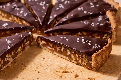 Candy Bar Pecan Tart sliced with a couple of slices removed - select to zoom
