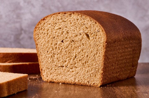 Classic 100% Whole Wheat Bread sliced on a counter showing the loaf's interior - select to zoom