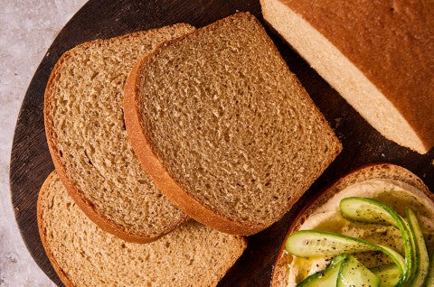 Classic 100% Whole Wheat Bread sliced on a cutting board - select to zoom