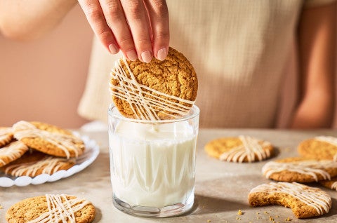 Dipping a brown butter cookie into a glass of milk - select to zoom