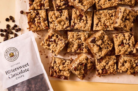 Carmelitas seen from above with a bag of King Arthur Baking's Bittersweet Chocolate chips - select to zoom