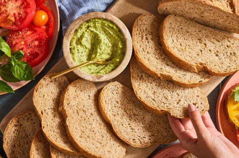 Slices of Seeded Multigrain Sourdough Bread on a cutting board - select to zoom