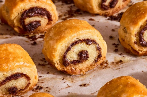 Close up of Chocolate Croissant Cookies on parchment fresh out of the oven - select to zoom