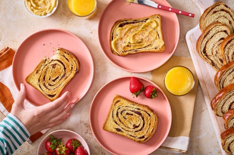 Slices of Sourdough Cinnamon Swirl Bread arranged on plates and seen from above - select to zoom