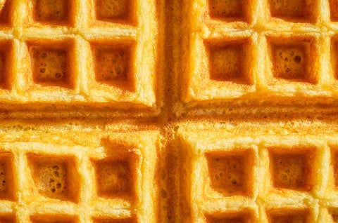 A close-up shot of a buttermilk waffle. - select to zoom