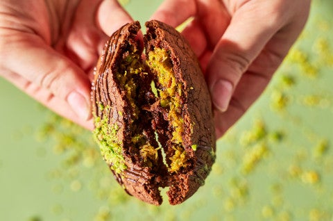 Breaking a Dubai Chocolate Cookie to show the pistachio filling - select to zoom