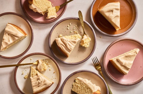 Slices of Frosted Brown Butter Cake on a variety of plates seen from above - select to zoom