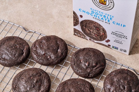 Gluten Free Nutella-Stuffed Cookies on a cooling rack with a box of gluten free double chocolate chip cookie mix in the background - select to zoom