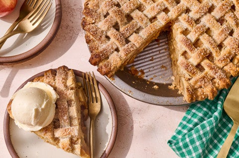 Gingered Apple Cream Pie seen from above with a lattice top crust and a slice on a plate topped with vanilla ice cream. - select to zoom