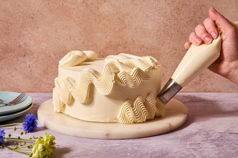 Piping Italian Buttercream onto a cake. - select to zoom