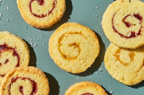 Any-Jam Pinwheel Cookies scattered on a counter - select to zoom