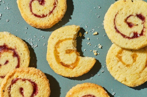 Any-Jam Pinwheel Cookies on a counter an done has a bite taken out of it - select to zoom