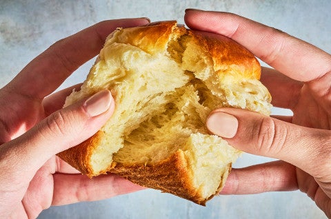 Breaking apart a Japanese Milk Bread Roll to show the pillowy interior. - select to zoom