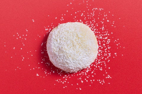 A Lemon Snowball Cookie on a red background - select to zoom