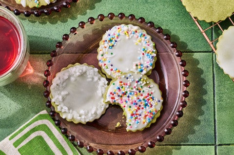 Glazed Matcha Cookies on a plate with a bite taken out of one - select to zoom
