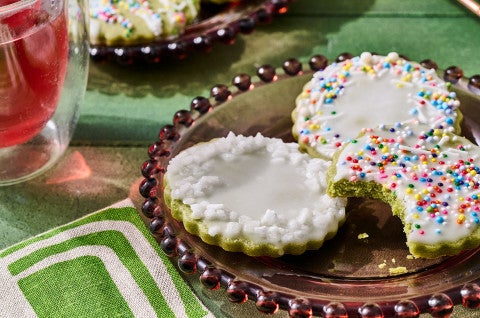 Glazed Matcha Cookies on a plate with a bite taken out of one - select to zoom