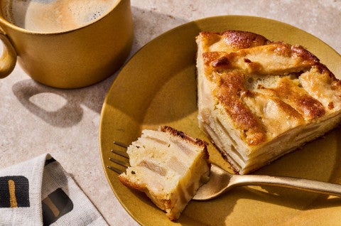A slice of Mostly Apples Apple Cake on a plate with a bite on a fork - select to zoom