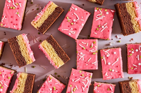 Neapolitan Sugar Cookie Bars scattered on a counter - select to zoom