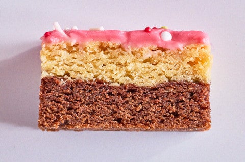A Neapolitan Sugar Cookie Bar seen from the side showing layers of chocolate, vanilla, and strawberry - select to zoom