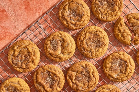 Pumpkin Snickerdoodle Cookies arranged on a cooling rack and seen from above - select to zoom