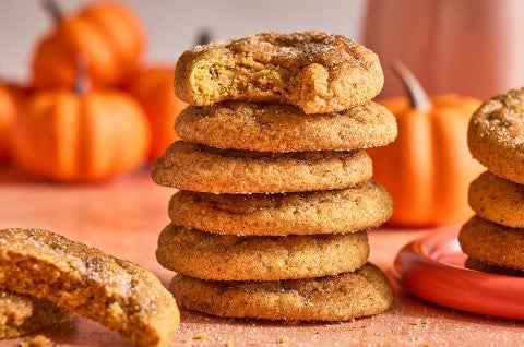 Pumpkin Snickerdoodle Cookies stacked on a counter - select to zoom