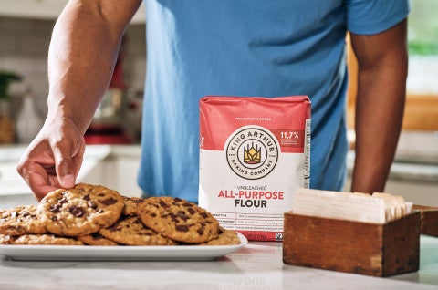 Grabbing an oatmeal chocolate chip cookie off a plate - select to zoom