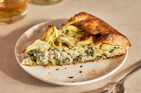 A slice of Spinach Artichoke Galette on a white plate - select to zoom