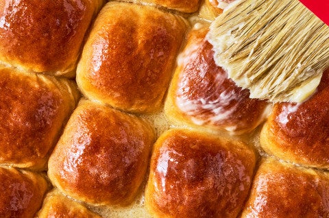 Brushing butter on top of Whole Wheat Dinner Rolls - select to zoom