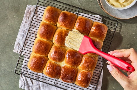 Brushing butter on Whole Wheat Dinner Rolls - select to zoom